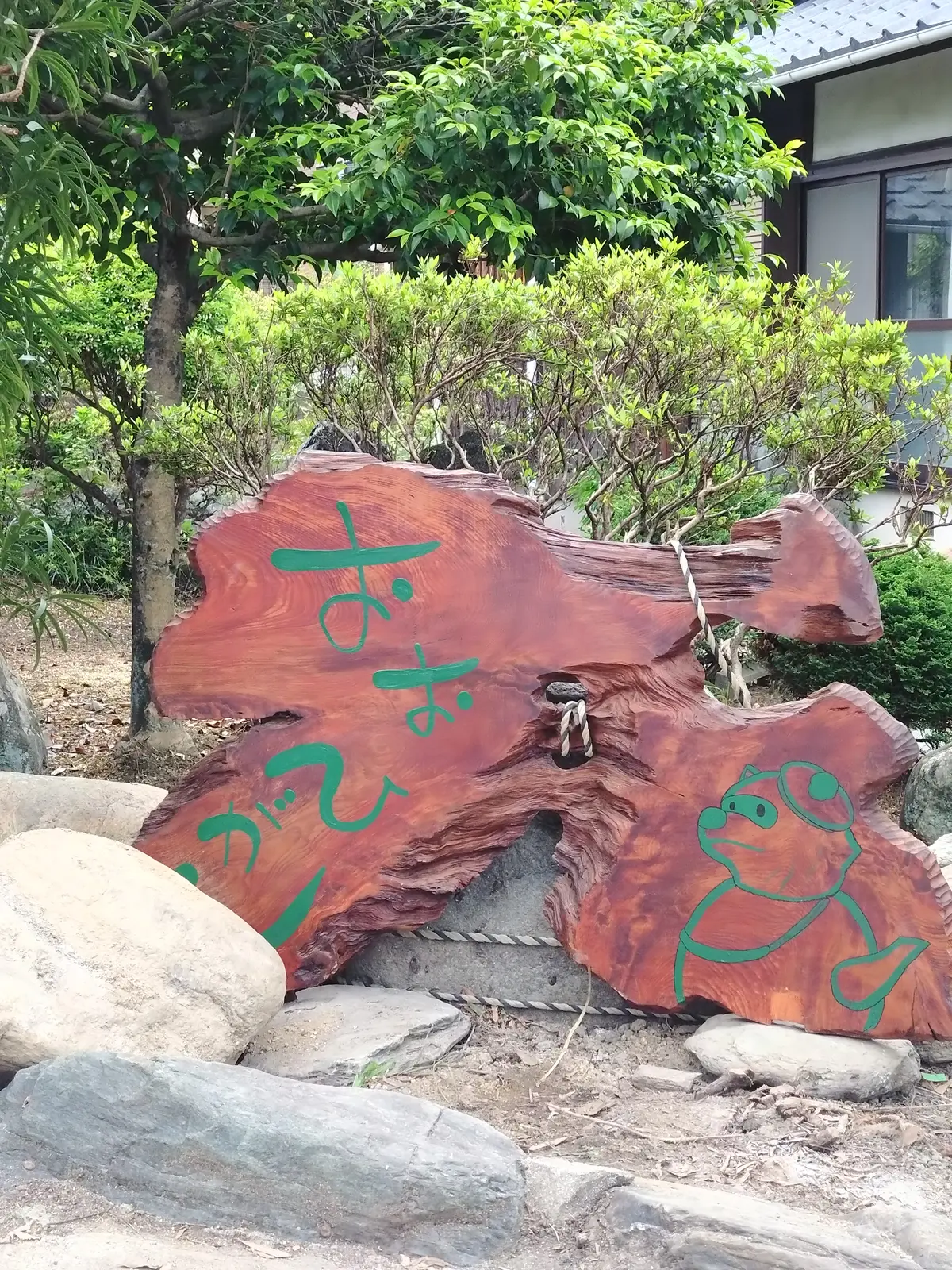 庭の石に立てかけられた完成した看板